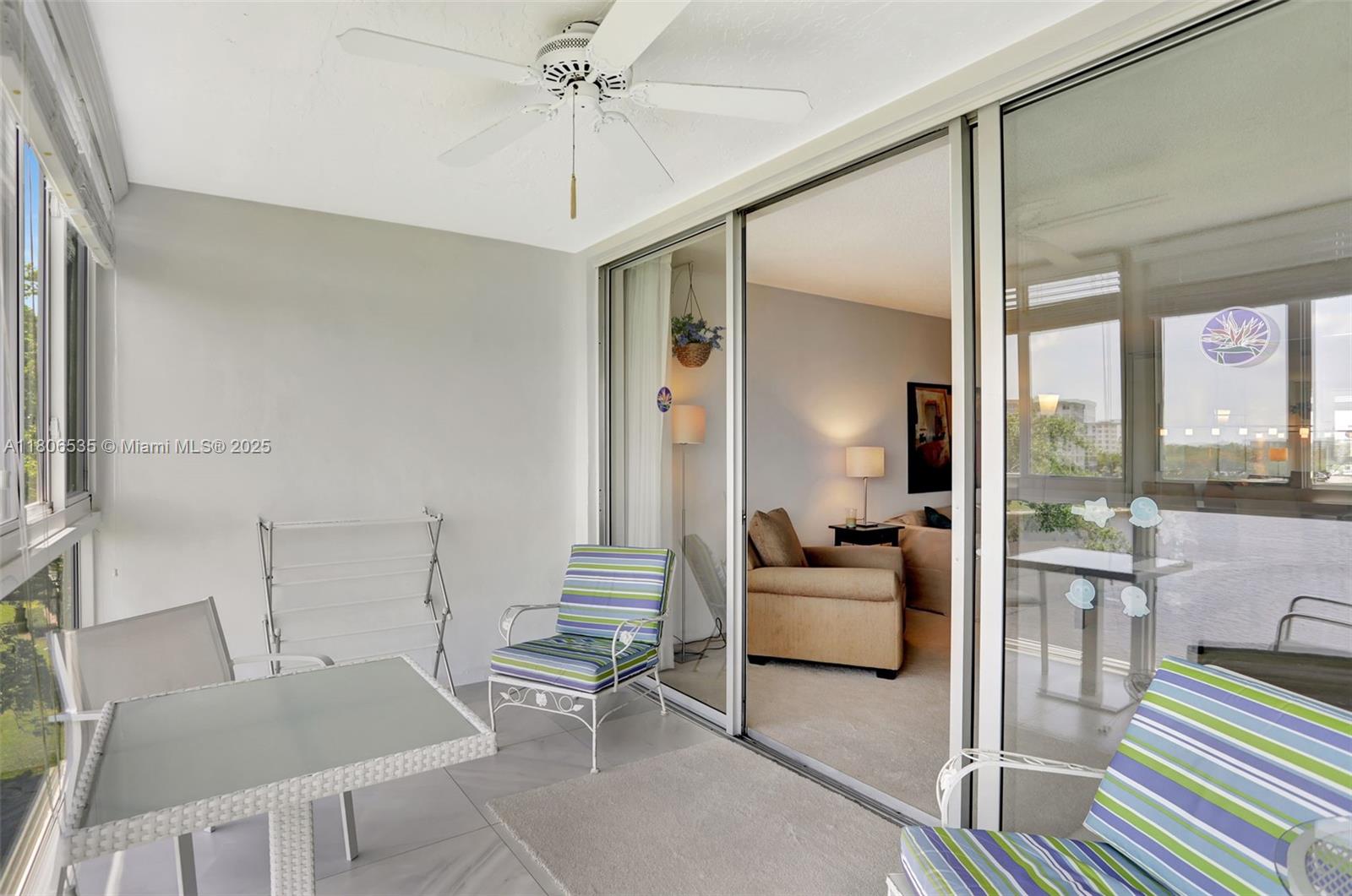 3091 North Course Drive, Unit 502 Pompano Beach, FL 33069 - Photo 28 of 42 a living room with furniture and a large window