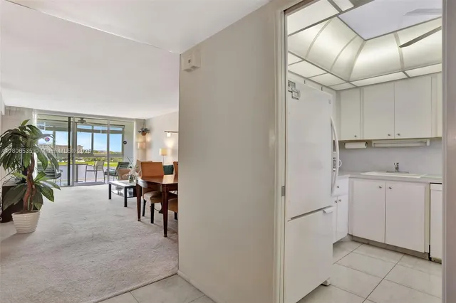 a view of kitchen with furniture and a refrigerator