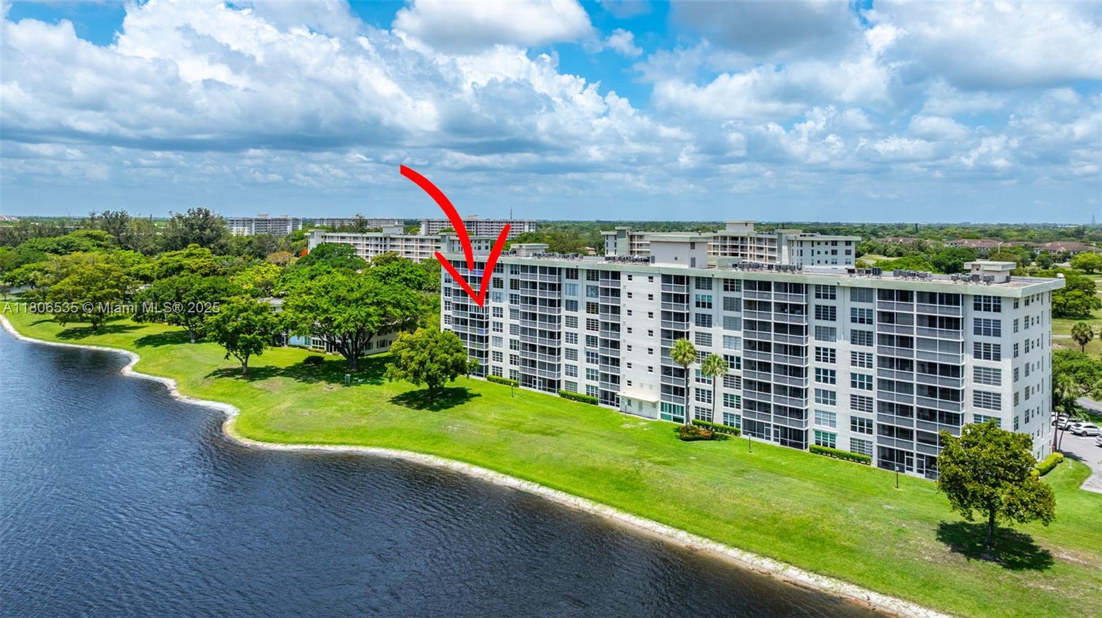 3091 North Course Drive, Unit 502 Pompano Beach, FL 33069 - Photo 33 of 42 a view of a house with a backyard and a garden