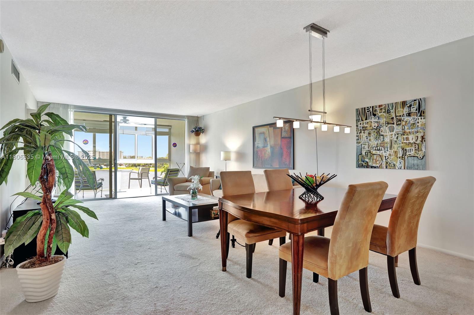 3091 North Course Drive, Unit 502 Pompano Beach, FL 33069 - Photo 7 of 42 a view of a livingroom and dining room with furniture wooden floor a chandelier