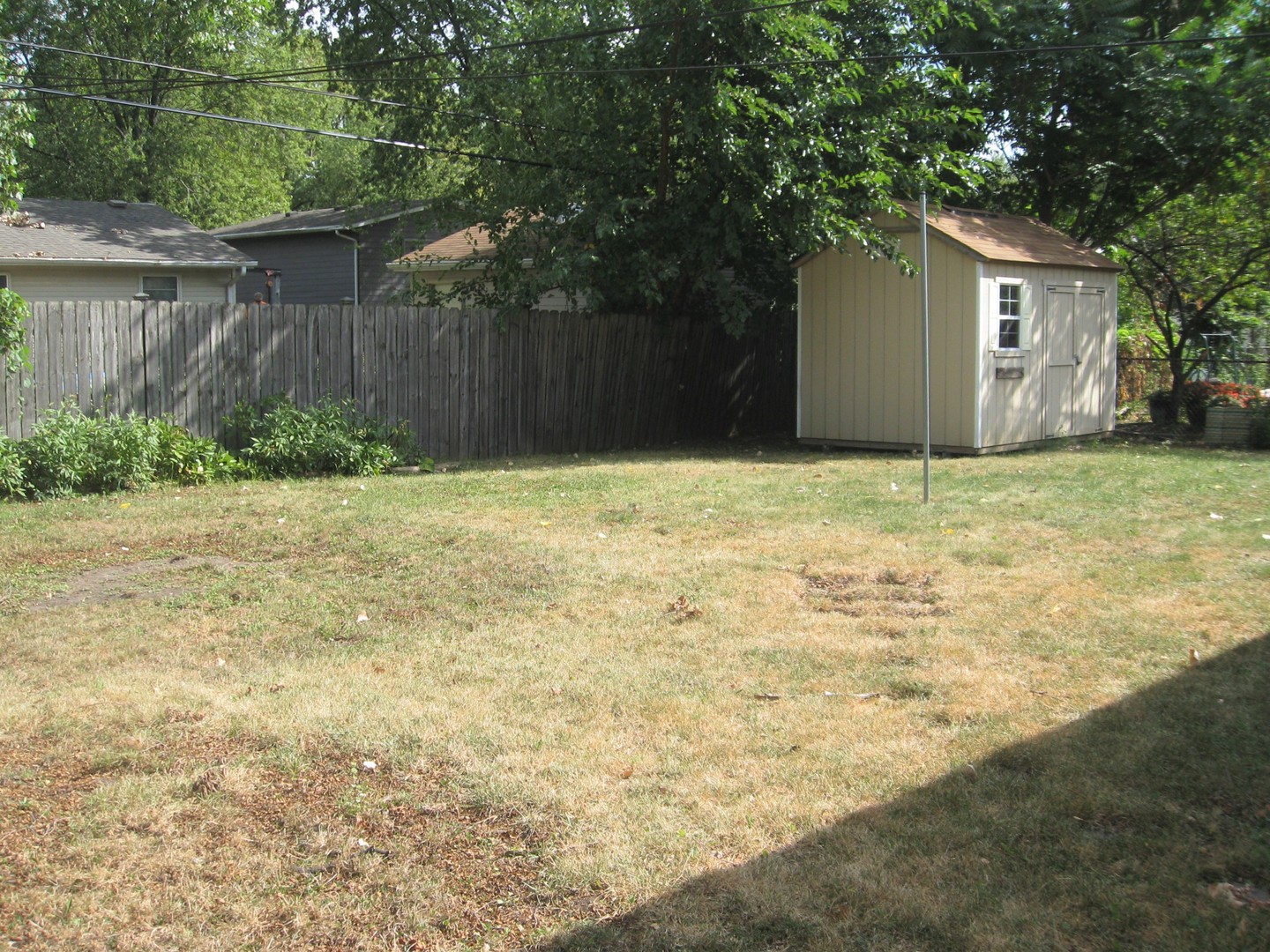 526 Spruce Road Bolingbrook, IL 60440 - Photo 11 of 13 a backyard of a house with plants and large tree