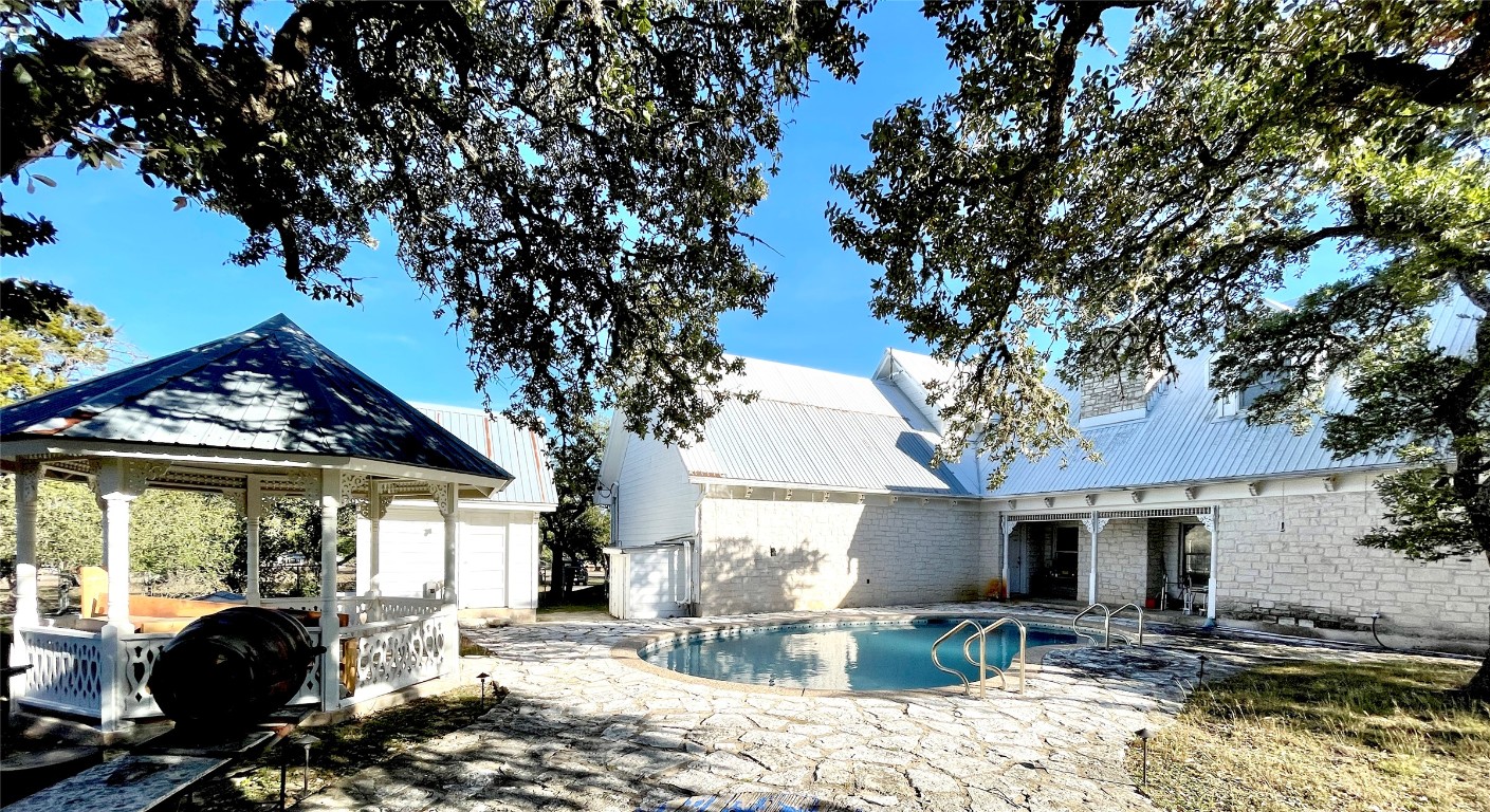 2 Sentinel Hill Austin, TX 78737 - Photo 17 of 40 a patio with sofas fire pit table and chairs