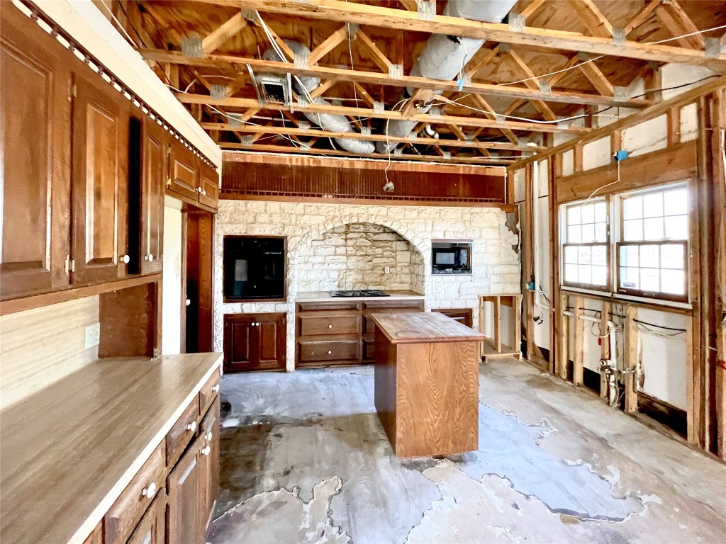 2 Sentinel Hill Austin, TX 78737 - Photo 37 of 40 a view of a kitchen with stainless steel appliances granite countertop a stove top oven