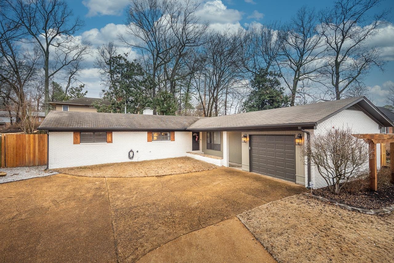 5641 Normandy Road Memphis, TN 38120 - Photo 1 of 25 a front view of a house with a yard and garage