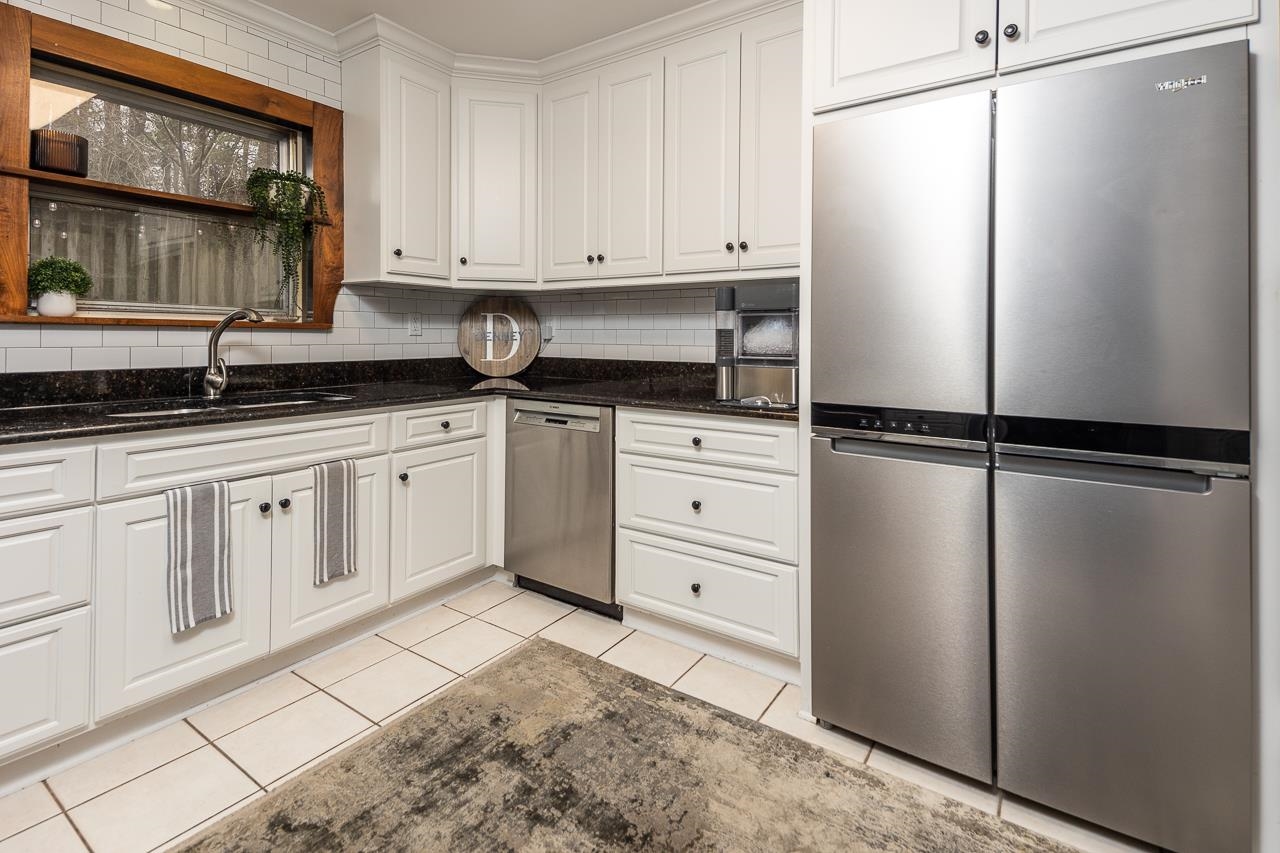 5641 Normandy Road Memphis, TN 38120 - Photo 11 of 25 a kitchen with granite countertop a refrigerator and cabinets