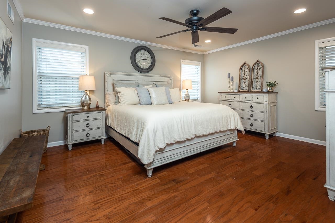 5641 Normandy Road Memphis, TN 38120 - Photo 14 of 25 a bedroom with a bed and a chandelier