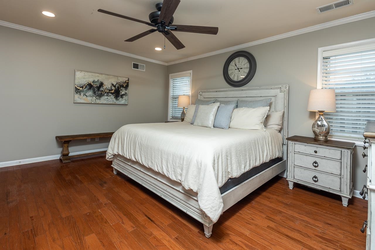 5641 Normandy Road Memphis, TN 38120 - Photo 15 of 25 a bedroom with a bed and a chandelier