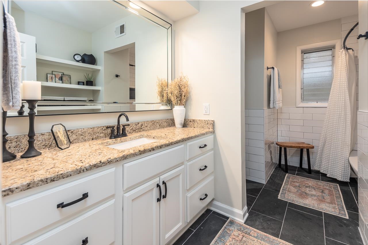 5641 Normandy Road Memphis, TN 38120 - Photo 19 of 25 a bathroom with a granite countertop sink and a mirror