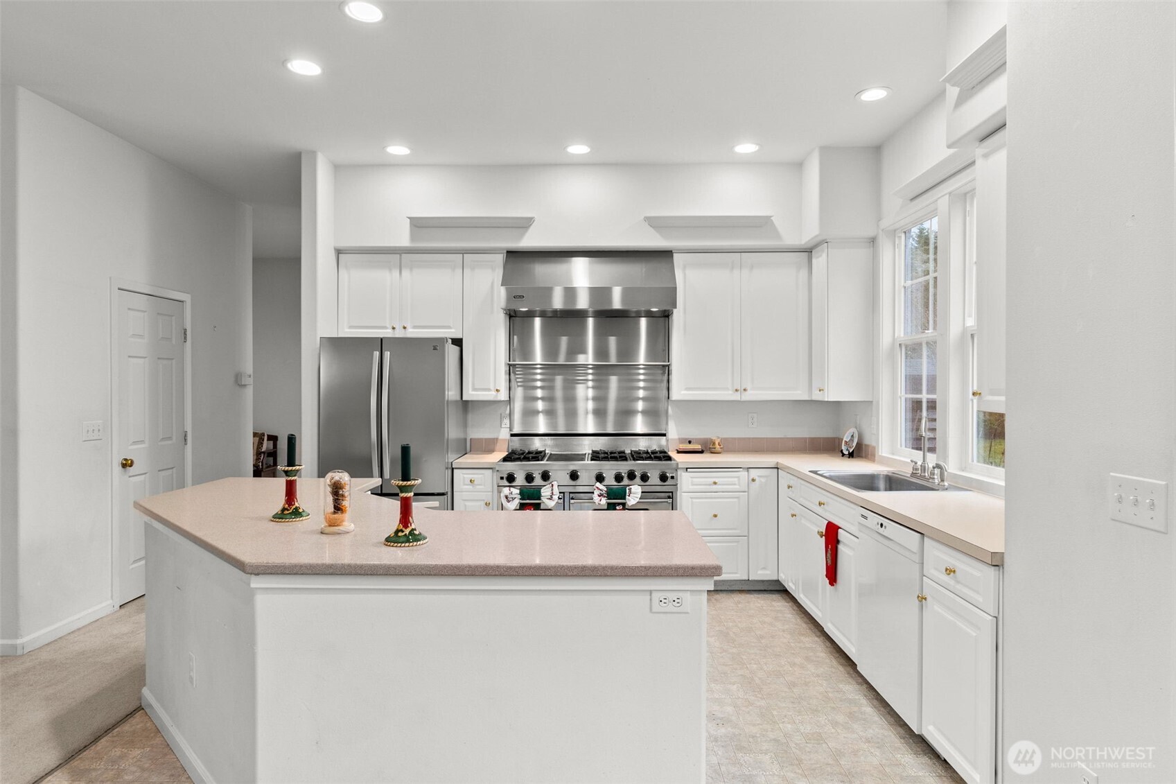 2312 Carnbee Court Southeast Lacey, WA 98513 - Photo 13 of 37 a kitchen with stainless steel appliances kitchen island granite countertop a sink and cabinets