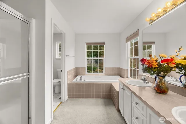 an empty room with a window and a kitchen