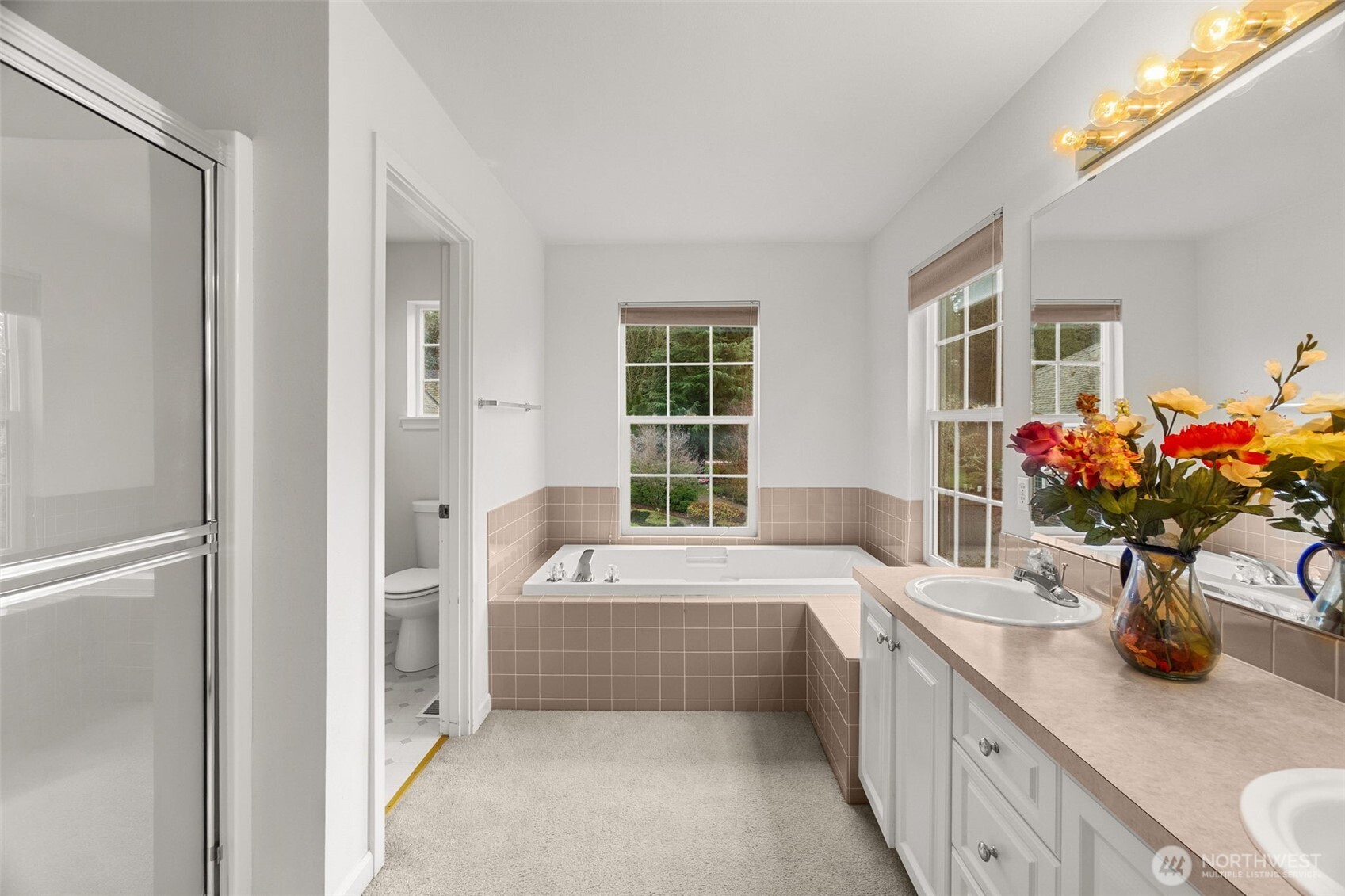2312 Carnbee Court Southeast Lacey, WA 98513 - Photo 24 of 37 a bathroom with a tub a sink and a large mirror