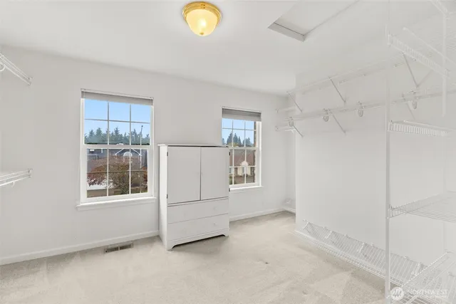 a bathroom with a sink double vanity granite tub and a mirror