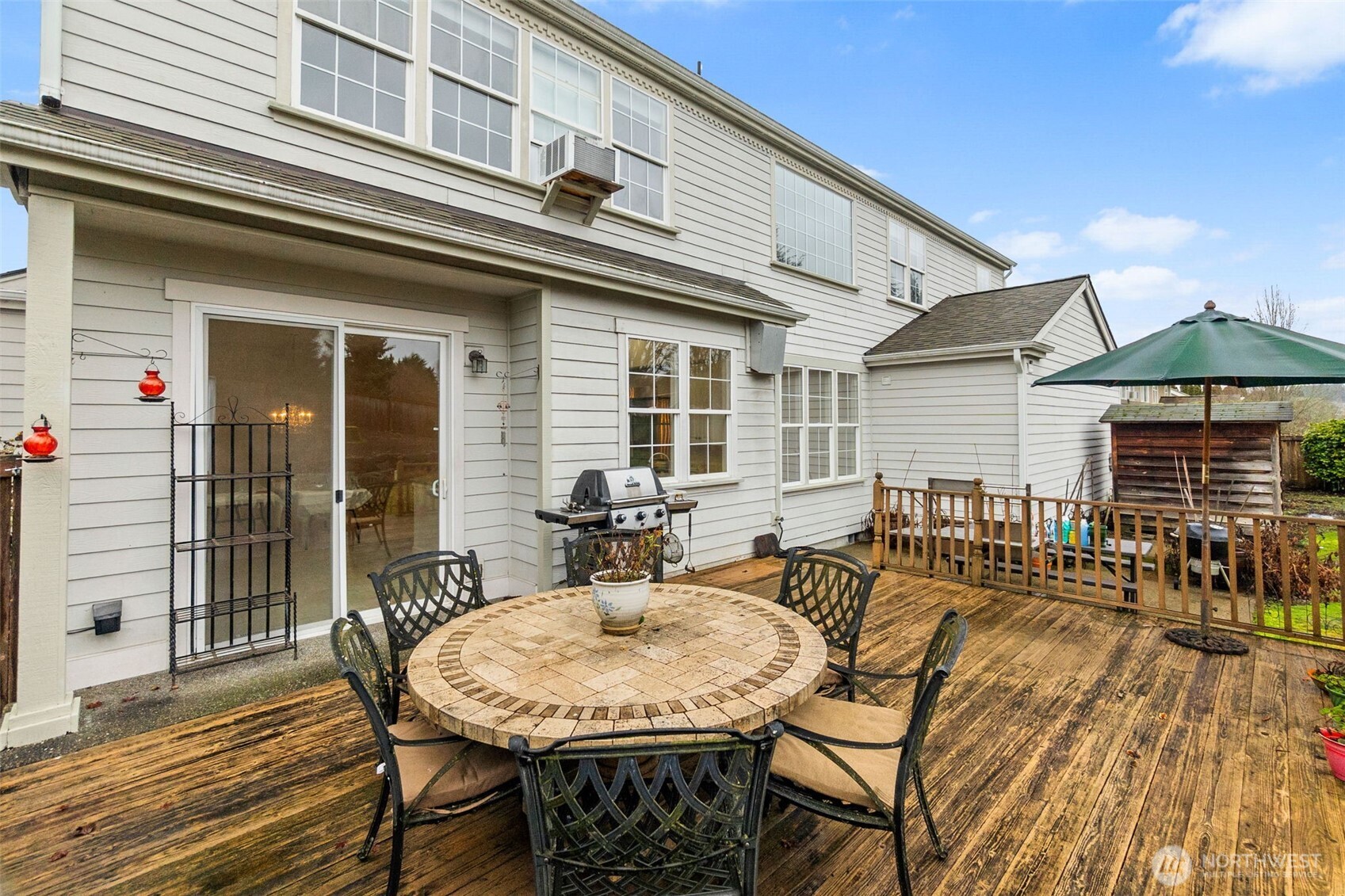2312 Carnbee Court Southeast Lacey, WA 98513 - Photo 37 of 37 a view of a patio with table and chairs with wooden floor and fence
