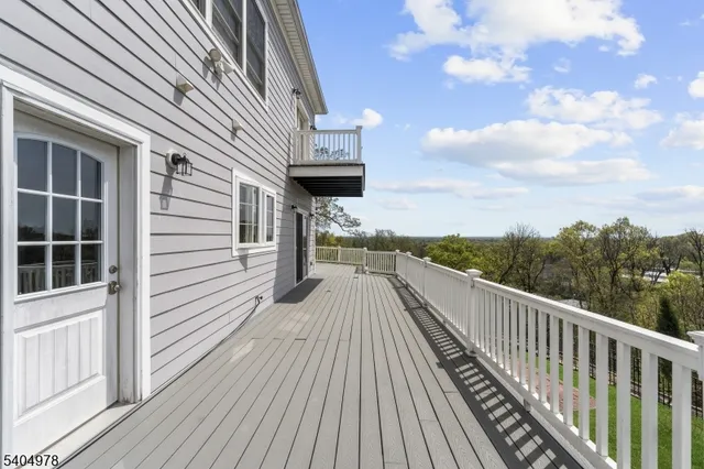 a view of balcony with wooden floor and fence