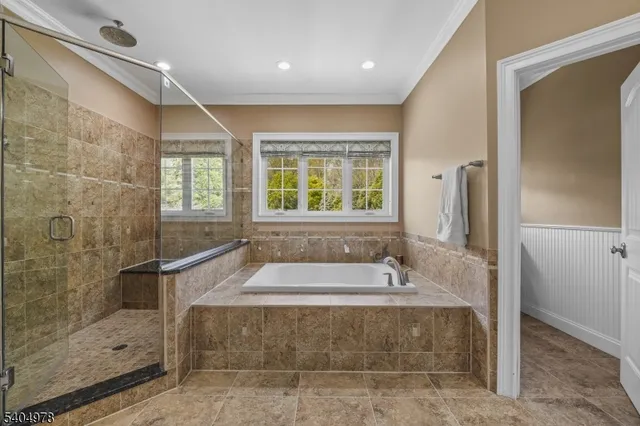 a bath tub sitting in a bathroom next to a window