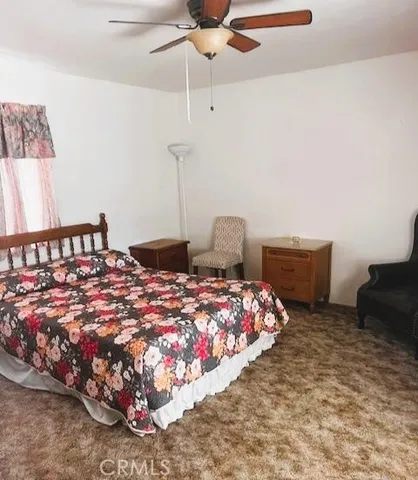 a bedroom with bed and a window