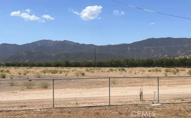 a view of a house with a yard and mountain view