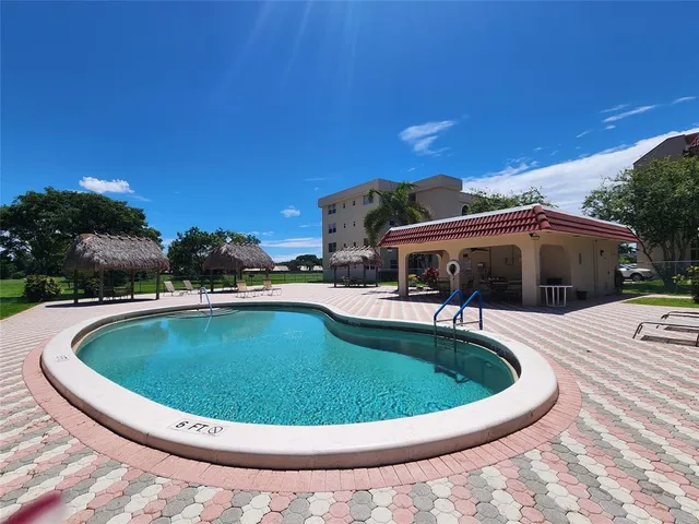 a view of a swimming pool with a patio