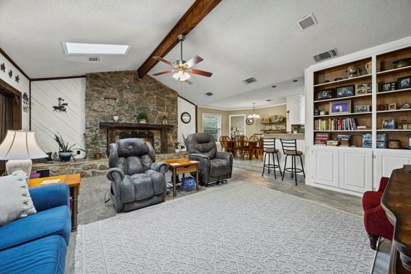 1816 Caddo Peak Road Joshua, TX 76058 - Photo 15 of 38 a living room with furniture kitchen view and a fireplace
