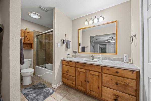 1816 Caddo Peak Road Joshua, TX 76058 - Photo 20 of 38 a spacious bathroom with a toilet a sink and a large mirror