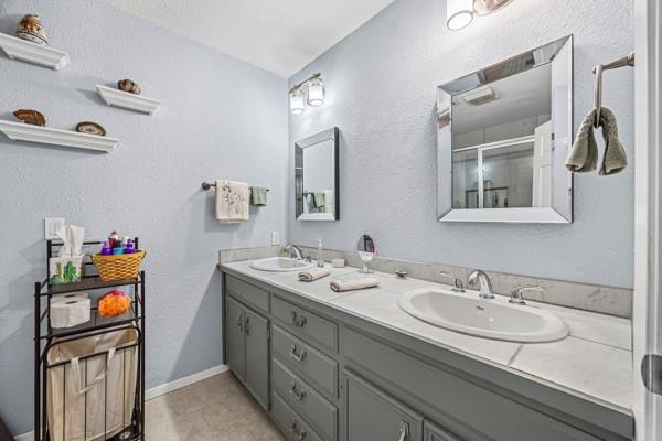 1816 Caddo Peak Road Joshua, TX 76058 - Photo 22 of 38 a bathroom with a sink double vanity and a mirror