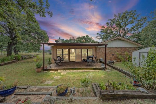 1816 Caddo Peak Road Joshua, TX 76058 - Photo 37 of 38 a view of a house with backyard and sitting area