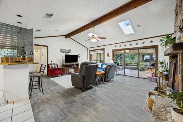 1816 Caddo Peak Road Joshua, TX 76058 - Photo 9 of 38 a living room with furniture a flat screen tv and floor to ceiling window