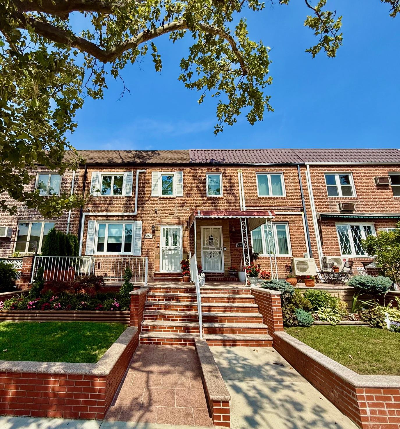 63-65 76th Street Queens, NY 11379 - Photo 1 of 1 a front view of a house with a yard