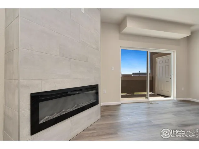 a view of kitchen with refrigerator and window