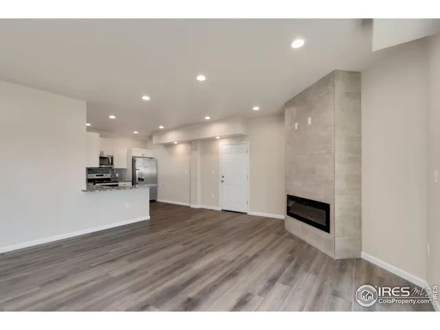 a kitchen with granite countertop a refrigerator and a sink