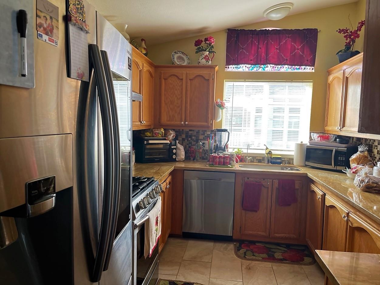 6130 Monterey Road, Unit 289 San Jose, CA 95138 - Photo 7 of 17 a kitchen with stainless steel appliances granite countertop a refrigerator and a sink