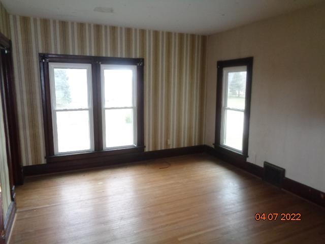 401 2nd Street Kings, IL 61068 - Photo 16 of 17 a view of an empty room with wooden floor and a window