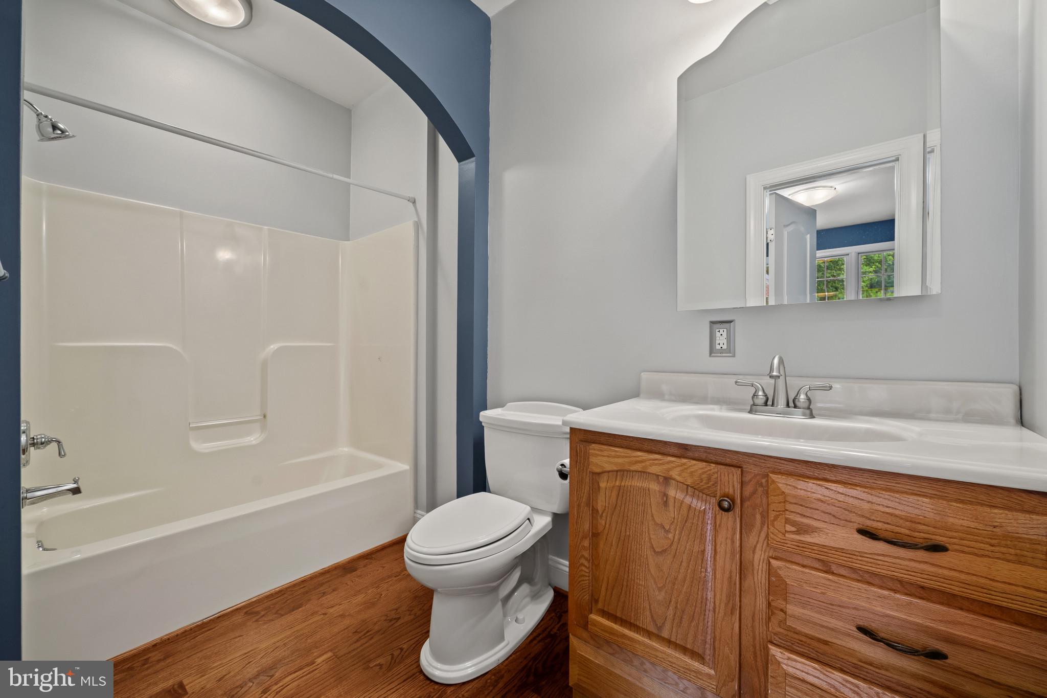 12221 Jerusalem Road Kingsville, MD 21087 - Photo 20 of 66 a bathroom with a granite countertop toilet sink and mirror