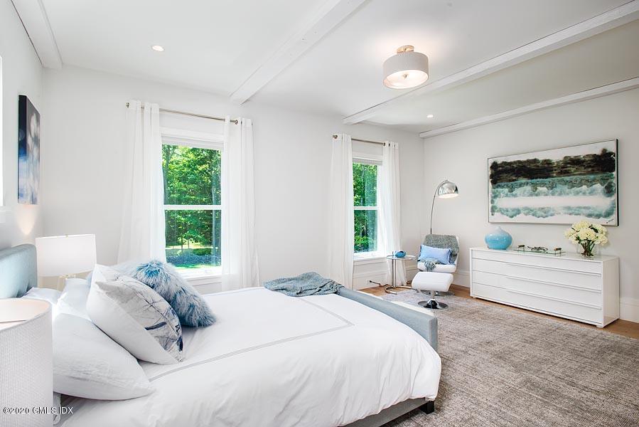 29 Goodsell Hill Road Redding, CT 06896 - Photo 21 of 29 a large bed sitting in a bedroom next to a window