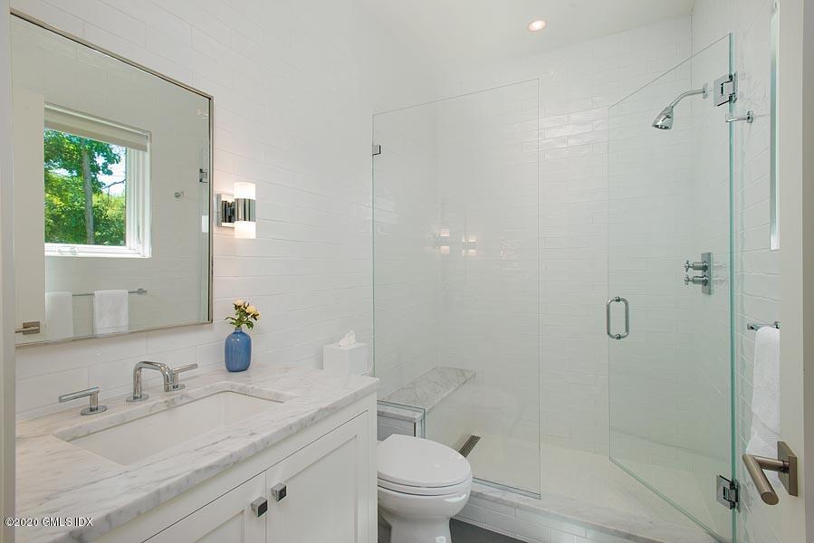 29 Goodsell Hill Road Redding, CT 06896 - Photo 22 of 29 a bathroom with a granite countertop sink a toilet and shower