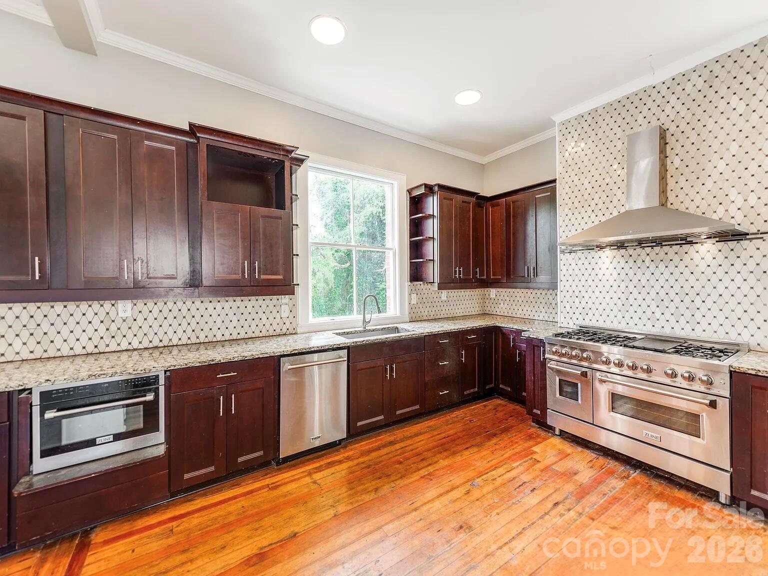 128 West End Street Chester, SC 29706 - Photo 11 of 40 a kitchen with stainless steel appliances granite countertop wooden cabinets stove top oven and sink