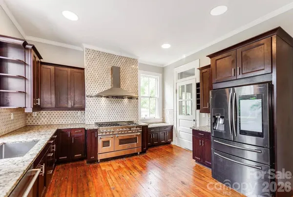 a kitchen with granite countertop stainless steel appliances and wooden cabinets