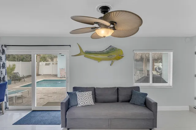 a view of a dining room with furniture a chandelier and kitchen view