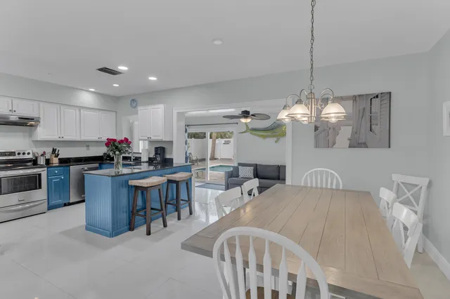 a kitchen with cabinets appliances a sink and a counter top space