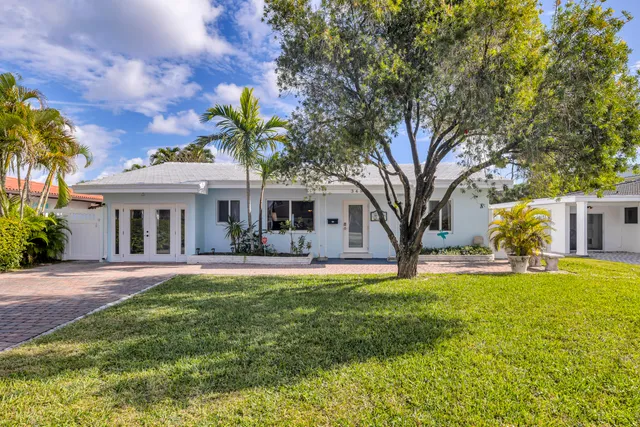 a living room with furniture and a dining table with kitchen view