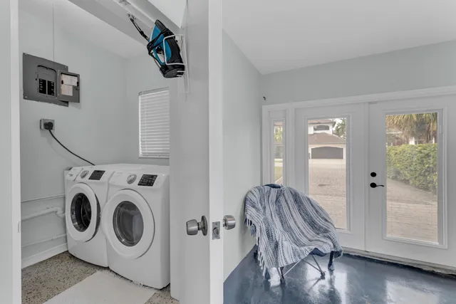 an aerial view of a house with a yard and a large swimming pool