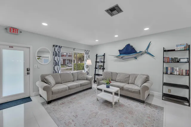 a living room with furniture and a lamp