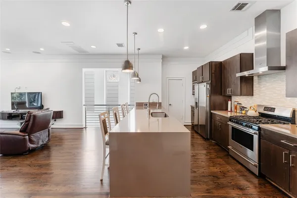 a large kitchen with stainless steel appliances kitchen island granite countertop a large center island attached withe living room