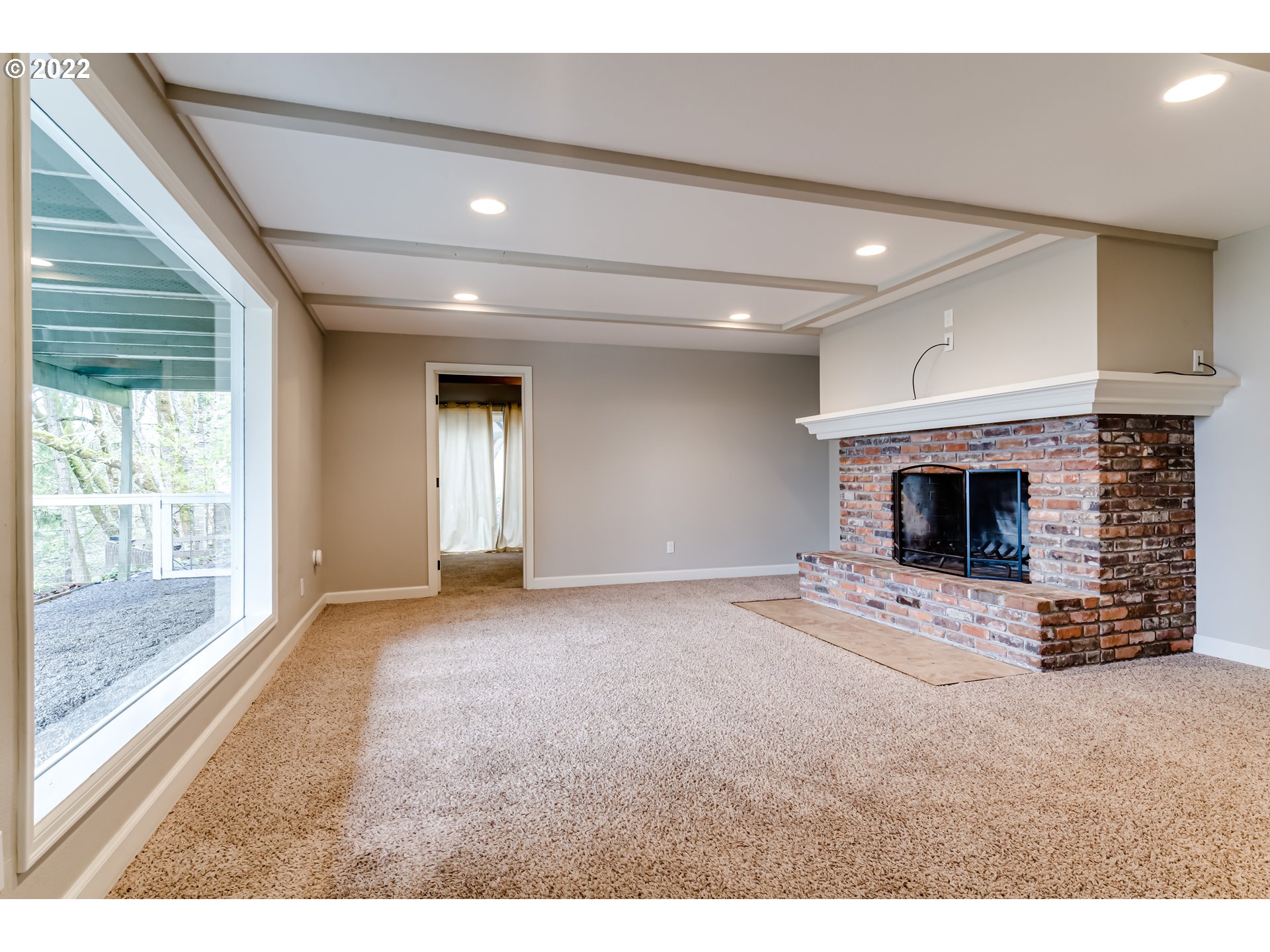 2655 Cresta De Ruta Street Eugene, OR 97403 - Photo 16 of 32 a view of an empty room with a fireplace and a window