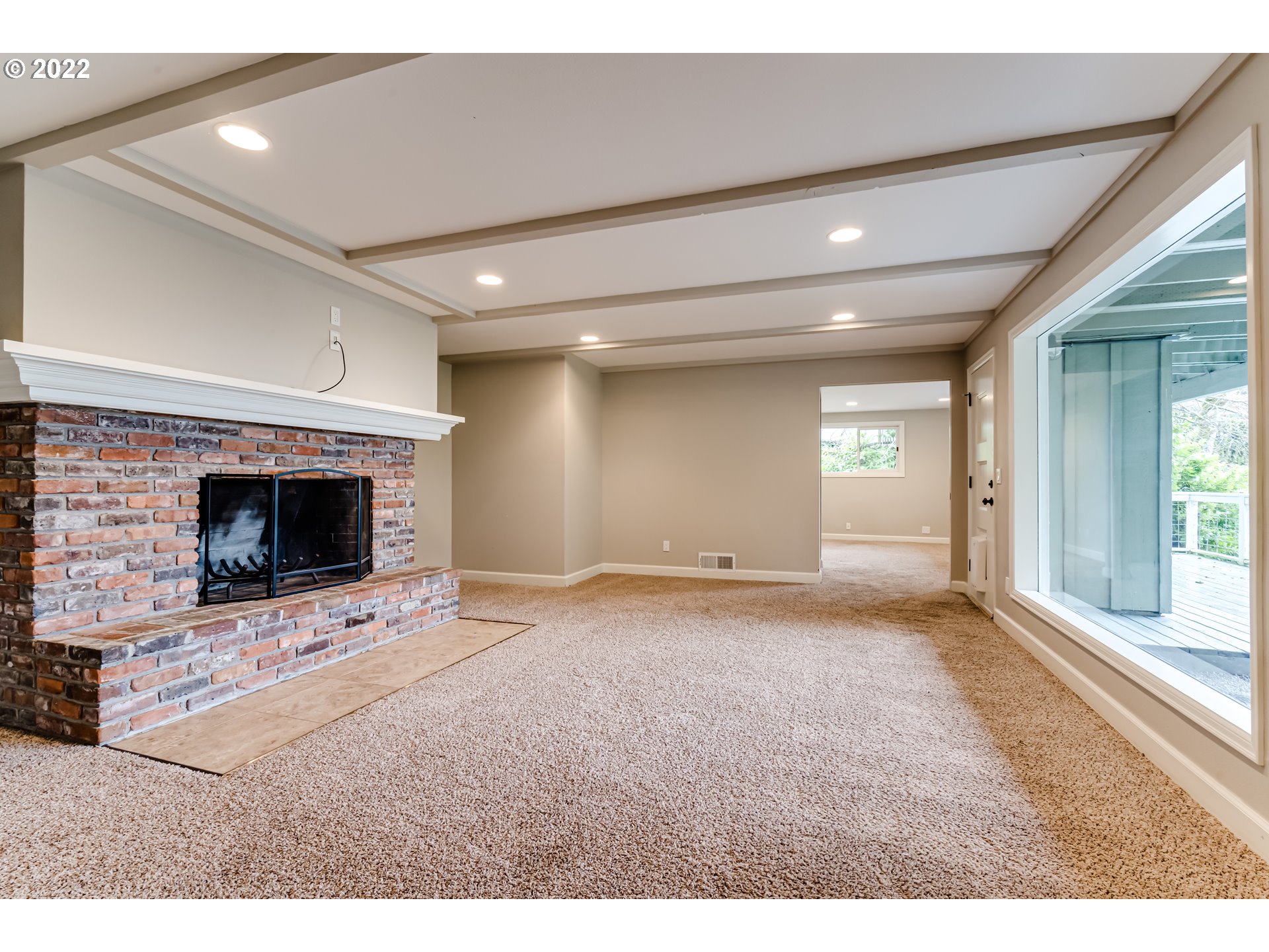 2655 Cresta De Ruta Street Eugene, OR 97403 - Photo 17 of 32 a view of an empty room with a fireplace and a window