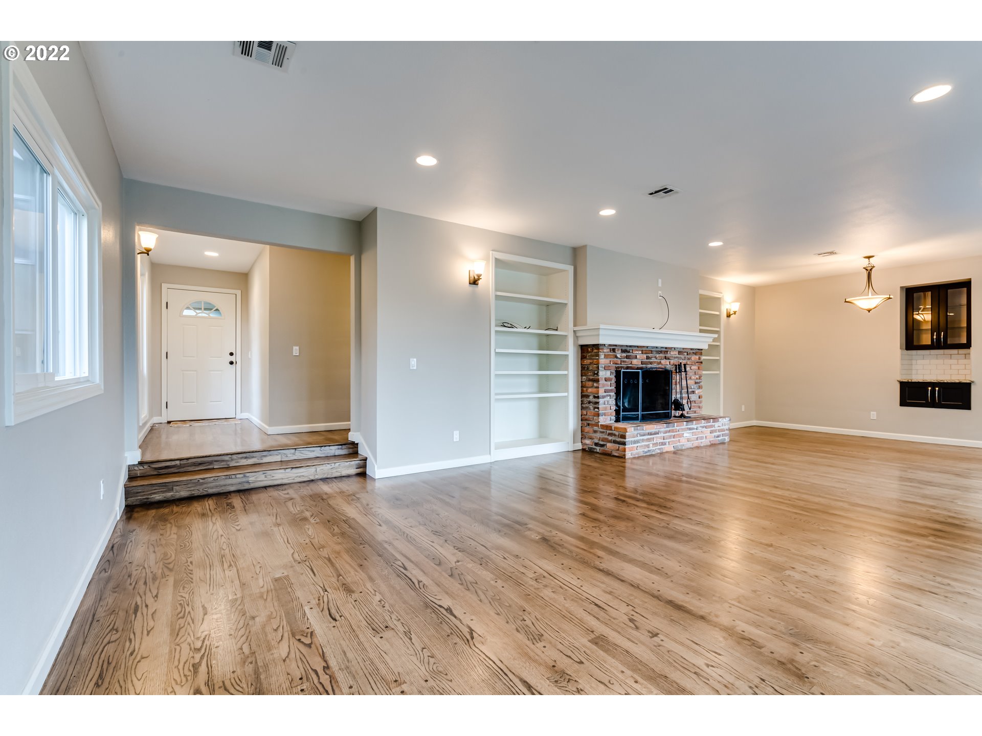 2655 Cresta De Ruta Street Eugene, OR 97403 - Photo 31 of 32 a view of empty room with wooden floor and a fireplace