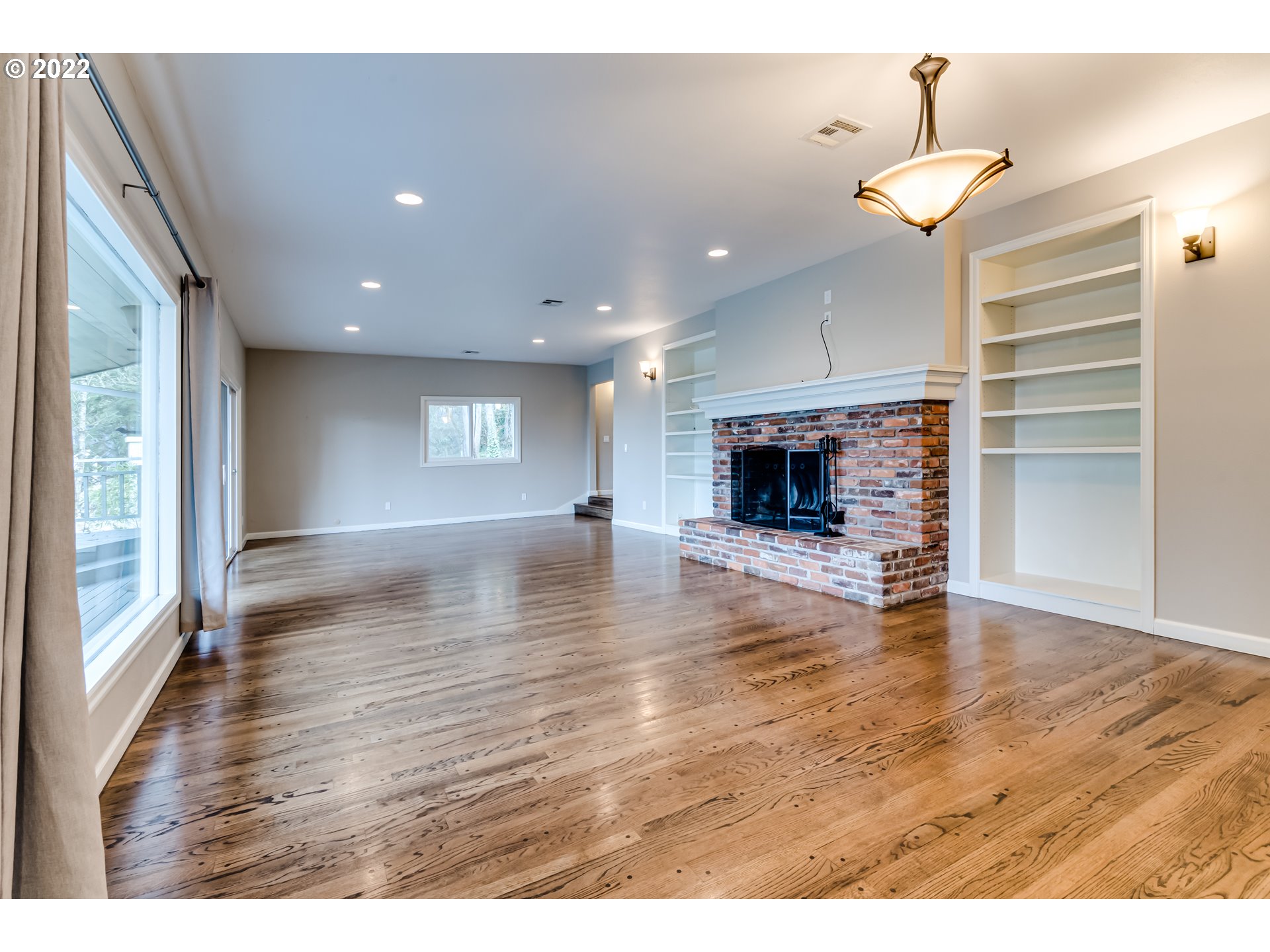 2655 Cresta De Ruta Street Eugene, OR 97403 - Photo 32 of 32 a view of a room with wooden floor fireplace and window
