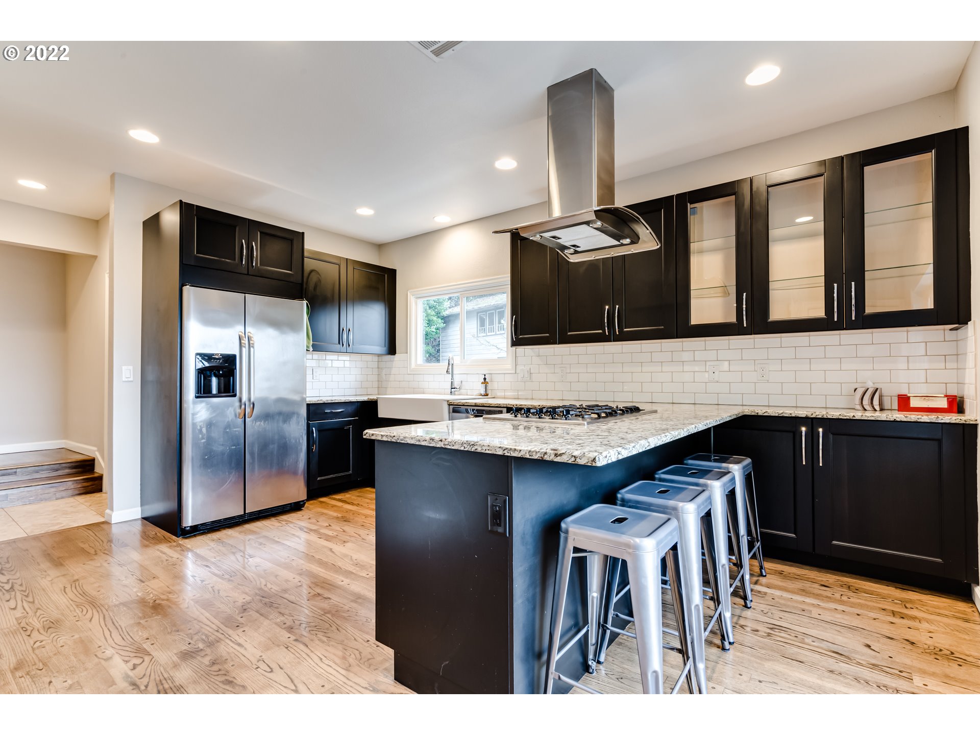 2655 Cresta De Ruta Street Eugene, OR 97403 - Photo 4 of 32 a kitchen with stainless steel appliances kitchen island granite countertop a refrigerator and a stove top oven