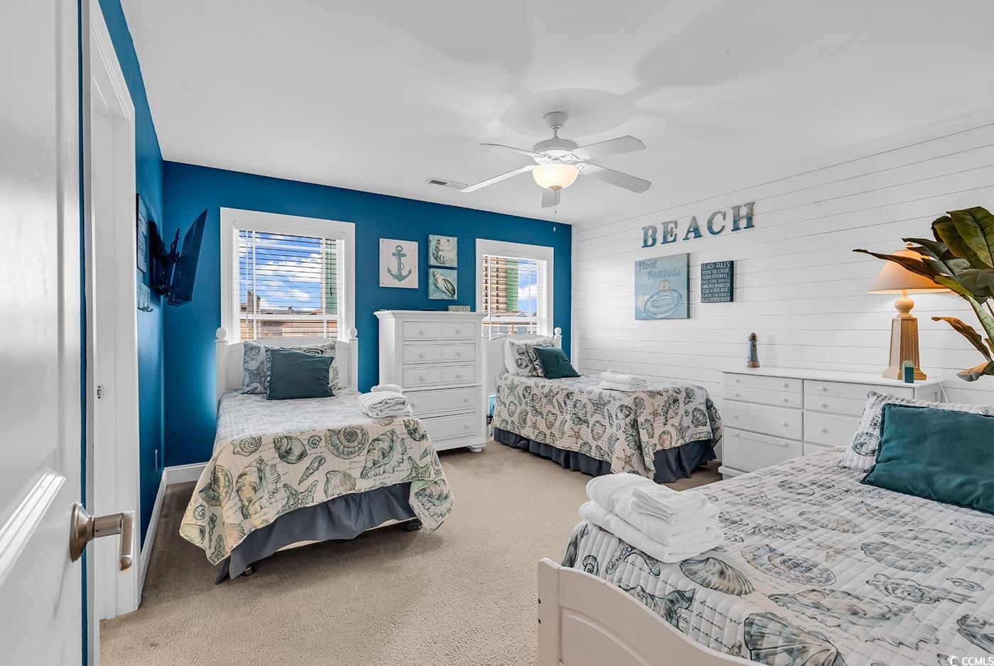 124 B Vista Drive Murrells Inlet, SC 29576 - Photo 25 of 38 Bedroom with wood walls, light colored carpet, a ceiling fan, and an accent wall