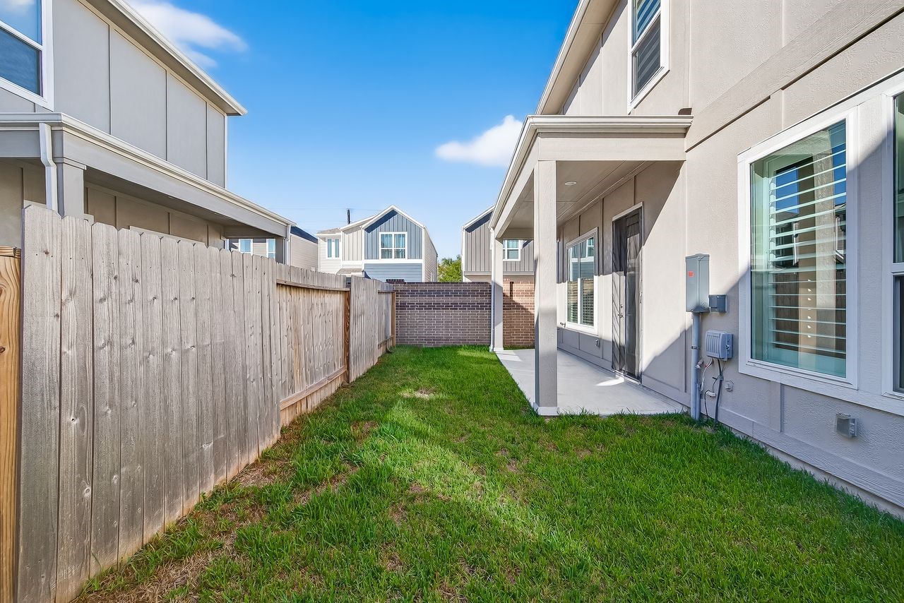 4209 Colony Pines Lane Houston, TX 77080 - Photo 23 of 30 a view of a house with brick walls and a yard with wooden fence